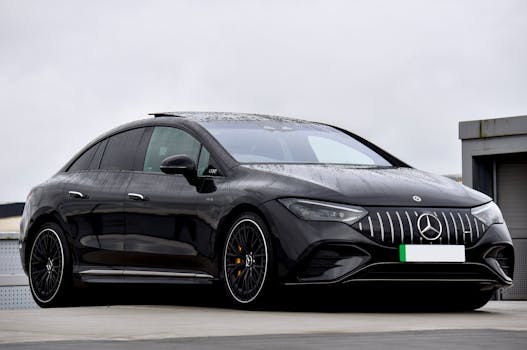 A stylish black Mercedes-Benz EQ electric car parked under cloudy skies, showcasing modern automotive design.