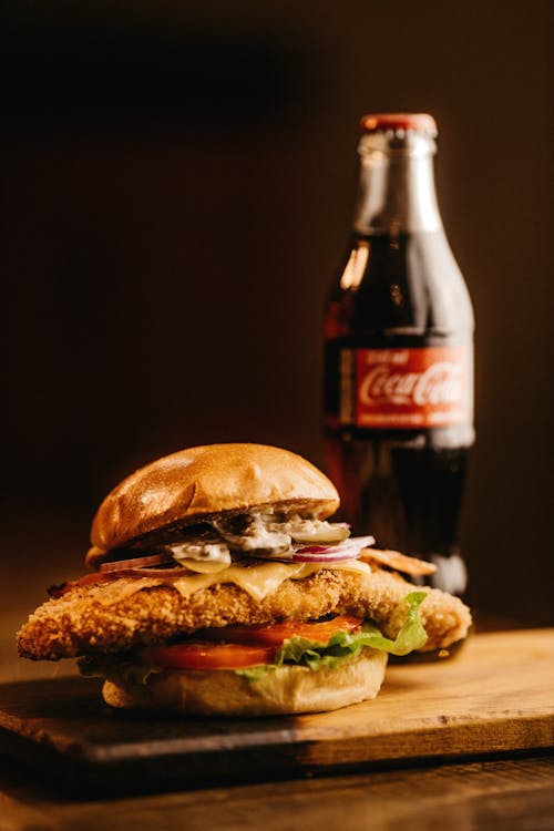 Close-Up Photo Of Burger Beside Coca-Cola