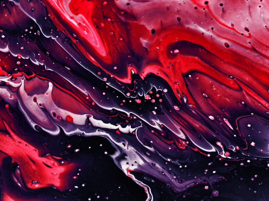 Dynamic abstract painting with red, black, and purple fluid acrylic textures.