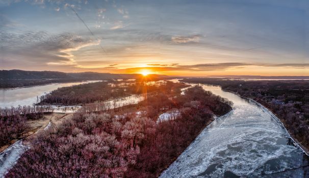 Stunning aerial view of a river surrounded by winter landscape at sunset in West Newton, Minnesota, USA.