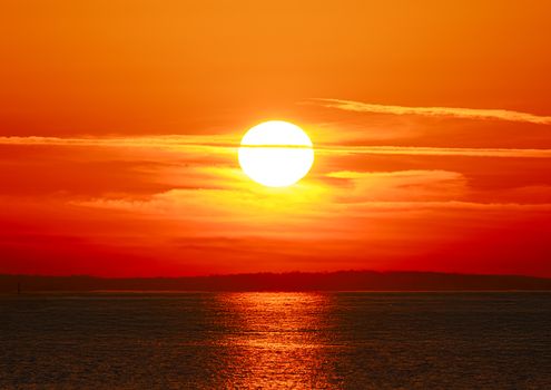 Breathtaking sunrise over the coast in Stamford, Connecticut with vivid autumn hues reflected in the water.