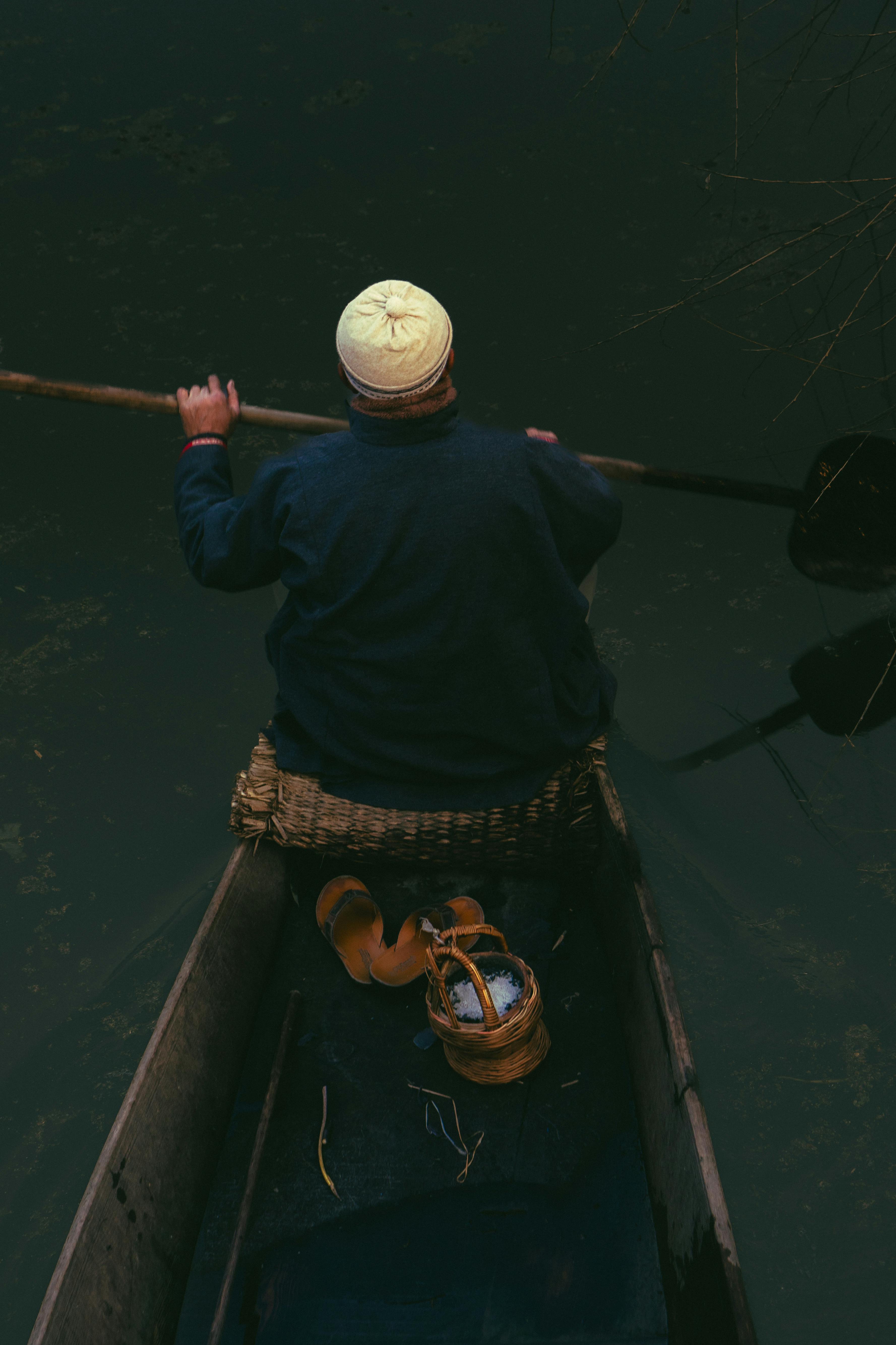 traditional boatman traversing calm waters