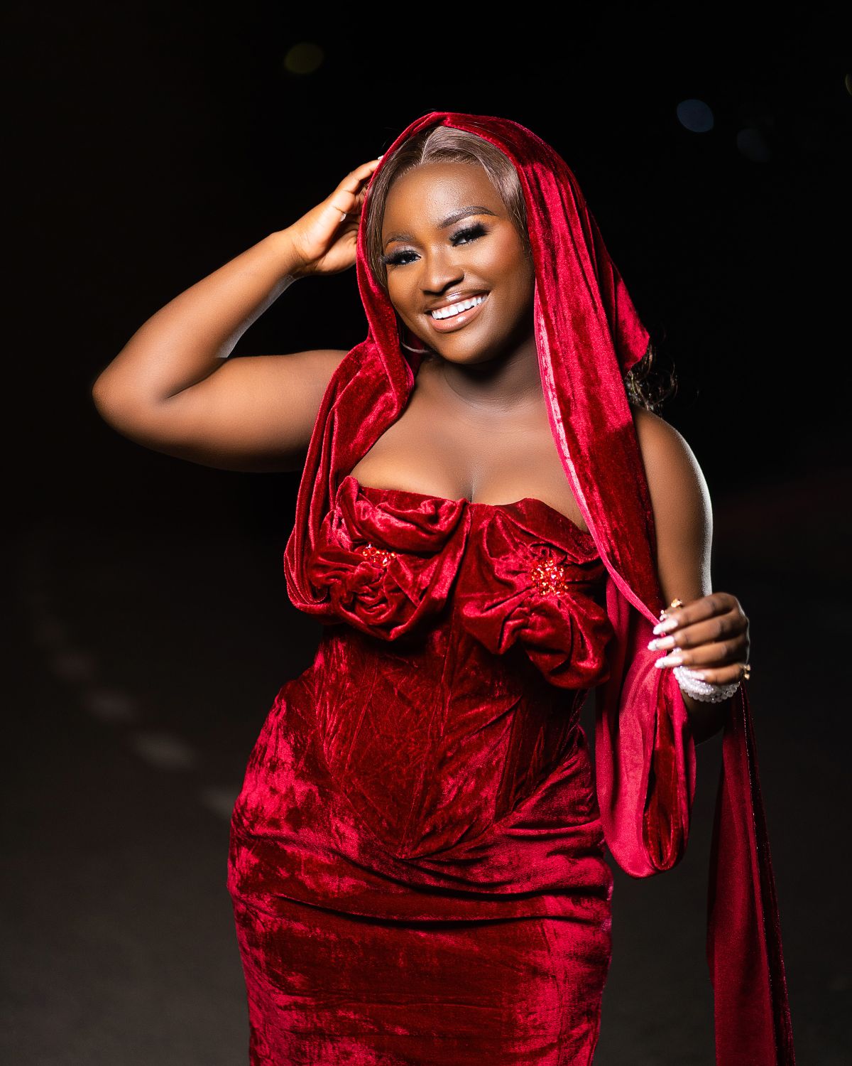 Plus size woman in a red velvet evening gown at night for a Christmas holiday party