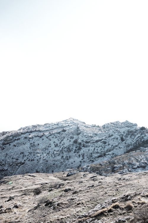 Free Tranquil mountain scene with snow-covered peaks and clear sky. Stock Photo