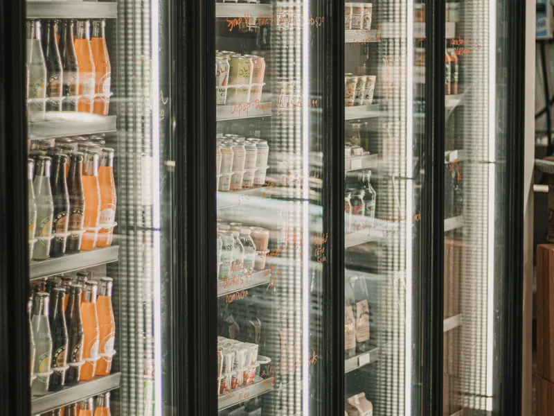 Grocery store with glass door refrigerated beverage and deli display coolers Grocery store with glass door refrigerated beverage and deli display coolers