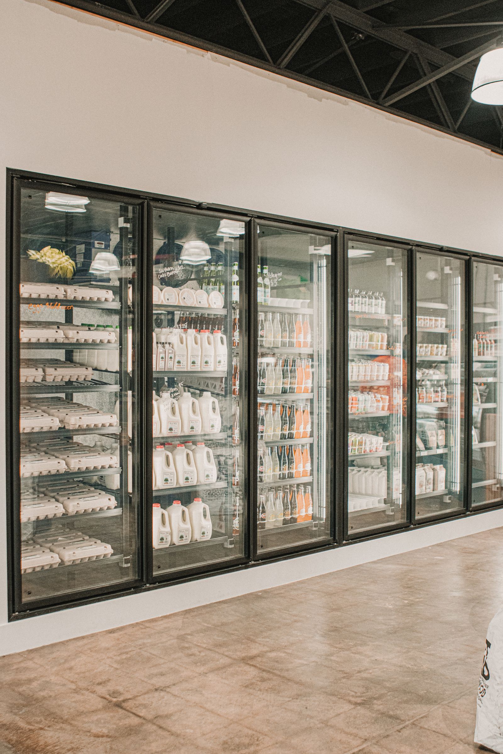 Refrigerated dairy section where butter packaging may face bright retail display light