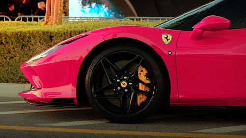 Free Close-up of a pink Ferrari in Dubai Marina showcasing luxury and style. Stock Photo