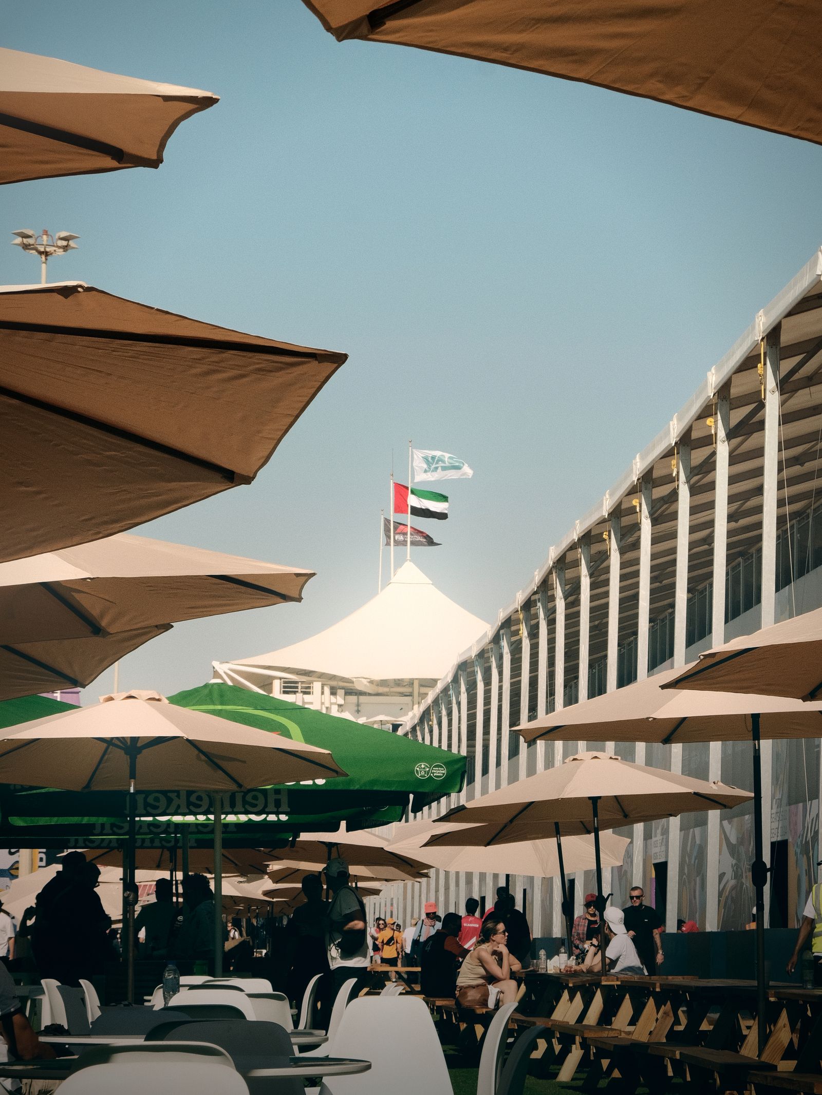 Umbrella-shaded seating and flags at Yas Marina Circuit