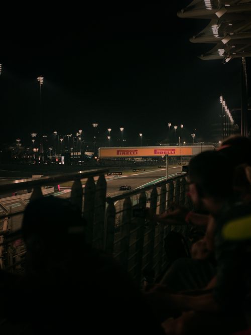 Free Fomula 1 Abu Dhabi Grand Prix | Ferrari Racing into the Night Stock Photo