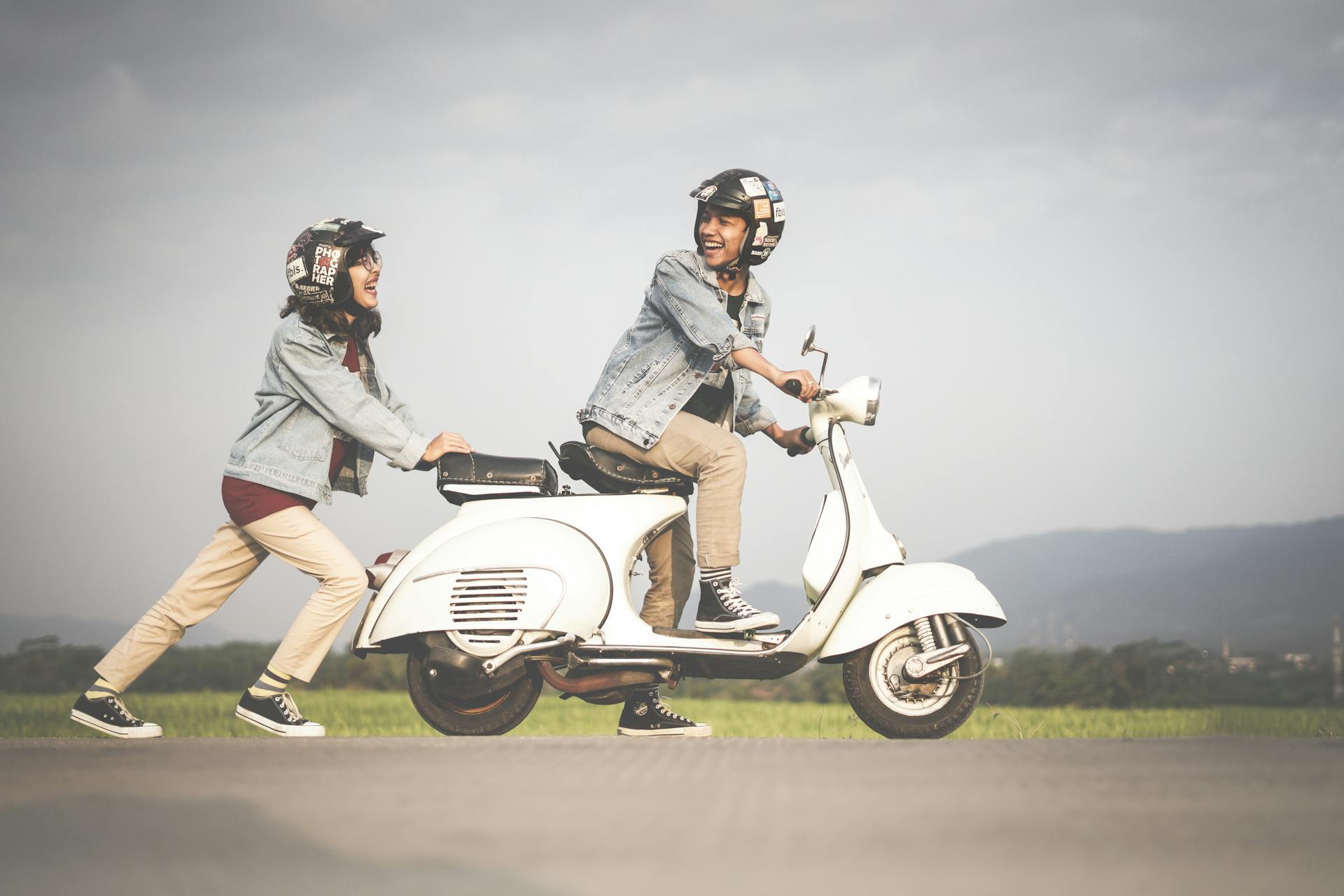 Woman Pushing A Scooter