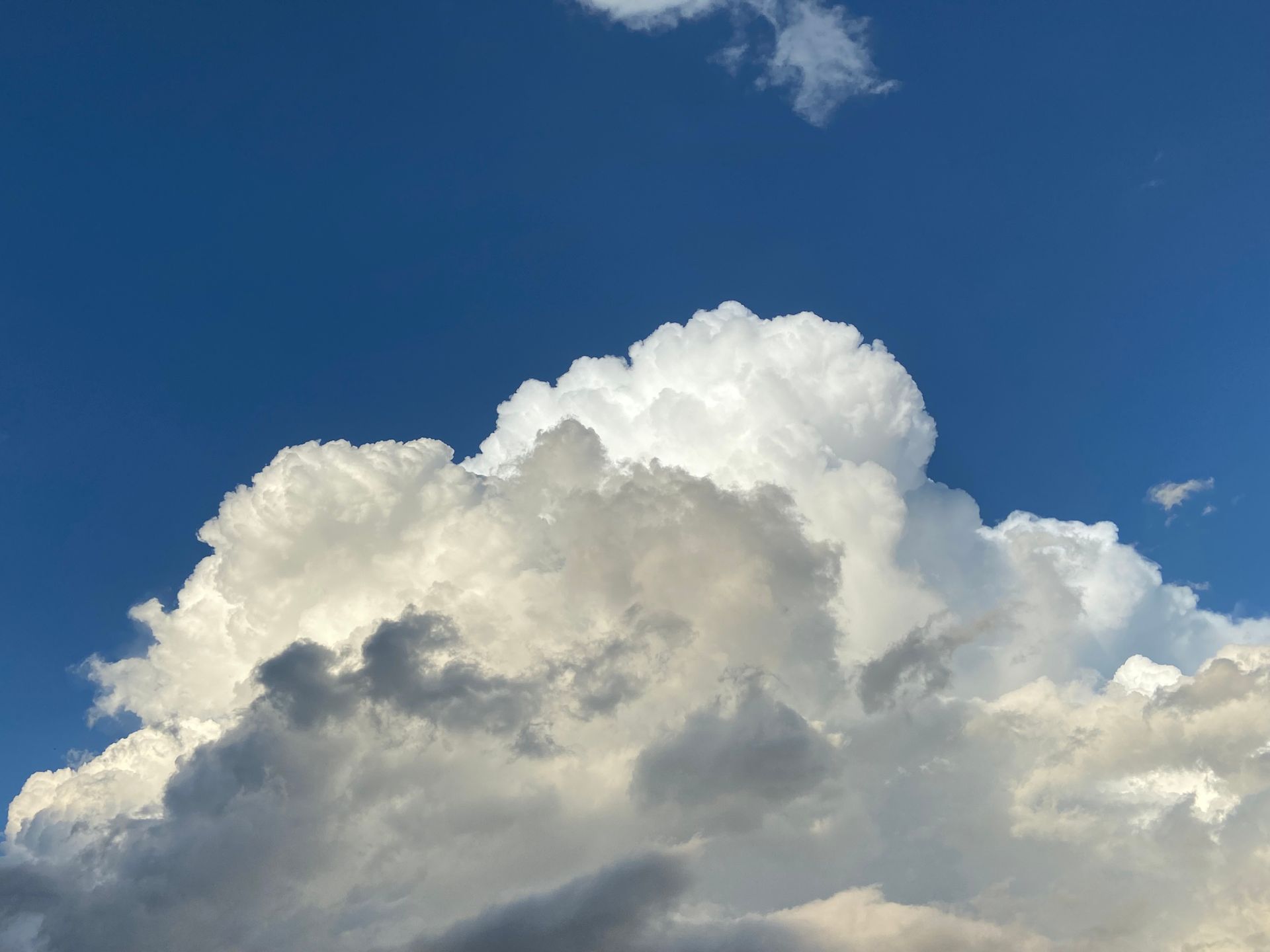 Majestic cumulus clouds with a vibrant blue sky background, perfect for nature and weather themes.