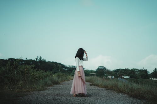 Side View of a Woman Standing Outdoors