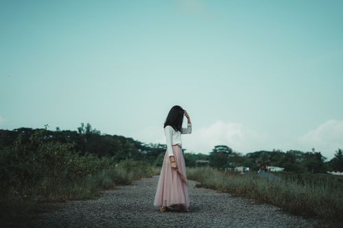 Free Woman in a stylish outfit standing on a rural path in Central Java, Indonesia. Stock Photo