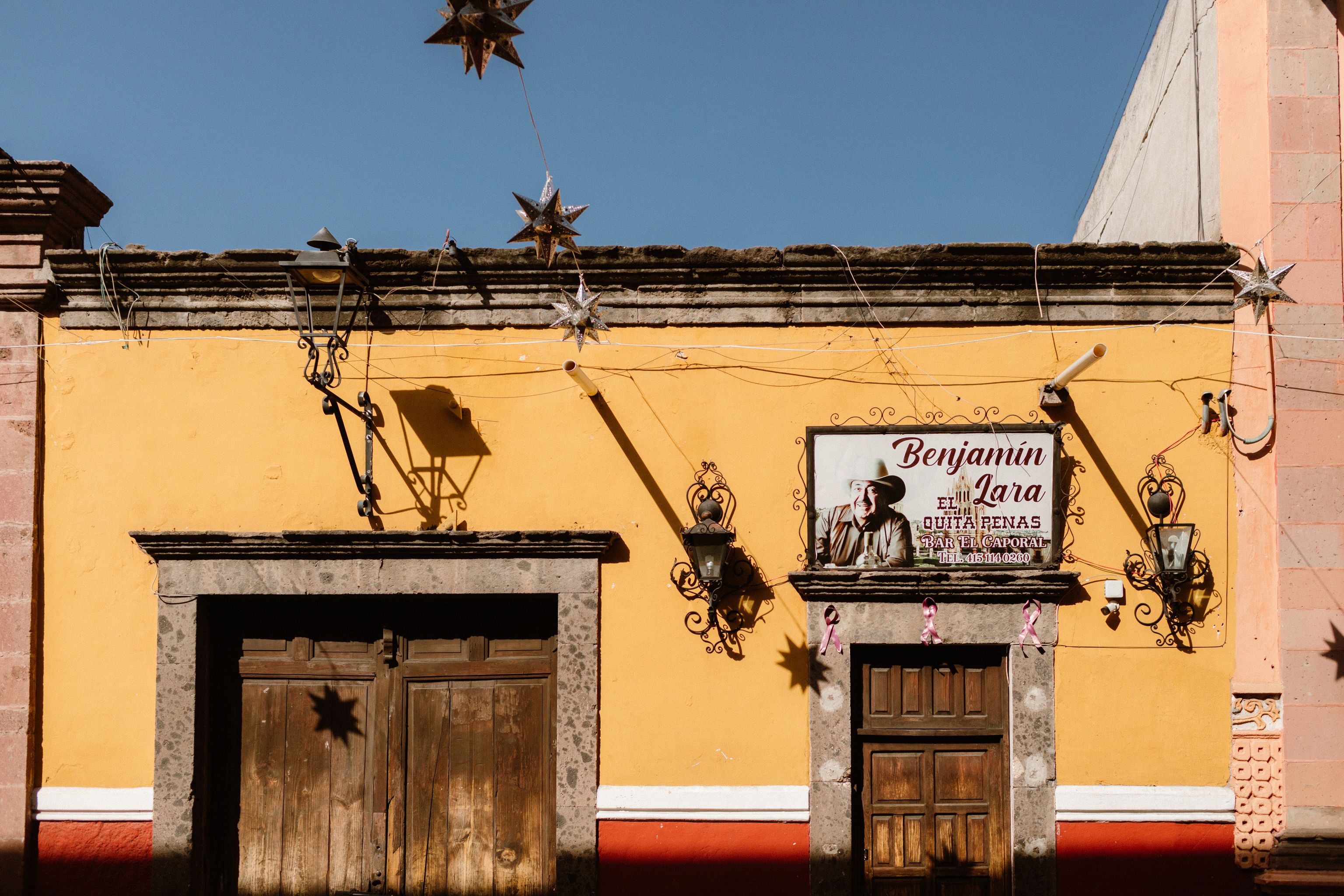 Vibrant yellow facade in San Miguel de Allende captures the essence of Mexican colonial architecture. - Guanajuato