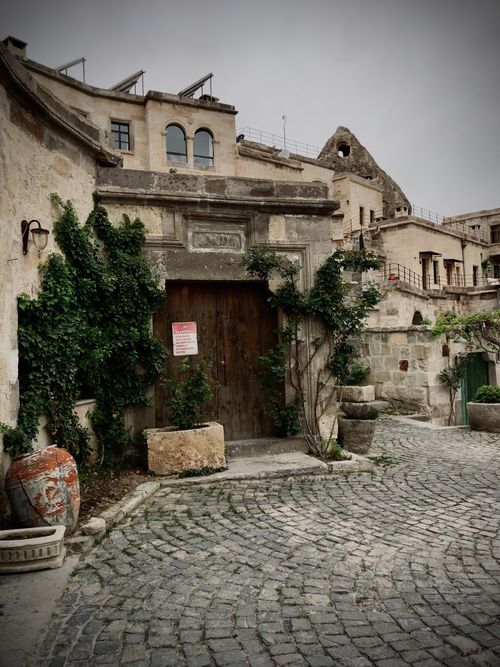 Free Timeless architecture with ivy-covered stone walls in Cappadocia's historic streets. Stock Photo