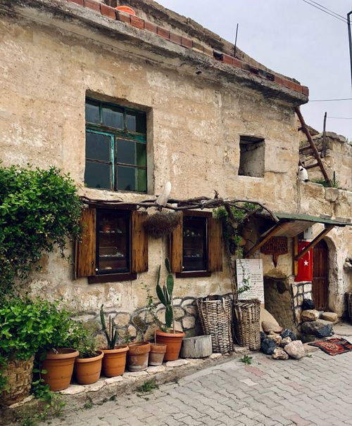 Free Charming rustic stone house with Turkish elements and potted plants outside. Stock Photo