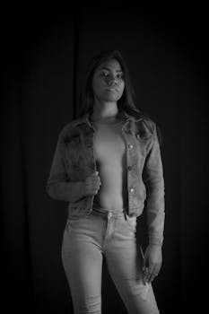 Elegant black and white portrait featuring a young woman in casual attire.