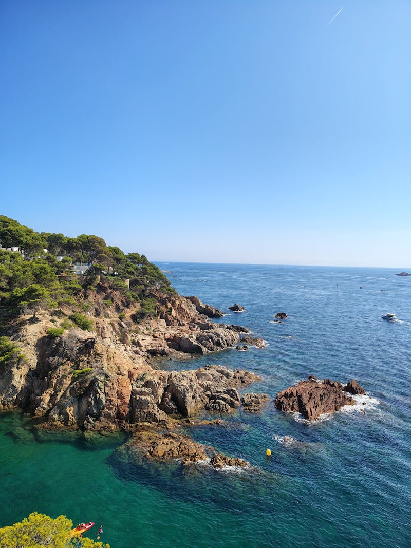 Rocky Mediterranean coastline with crystal clear turquoise water on a sunny summer day