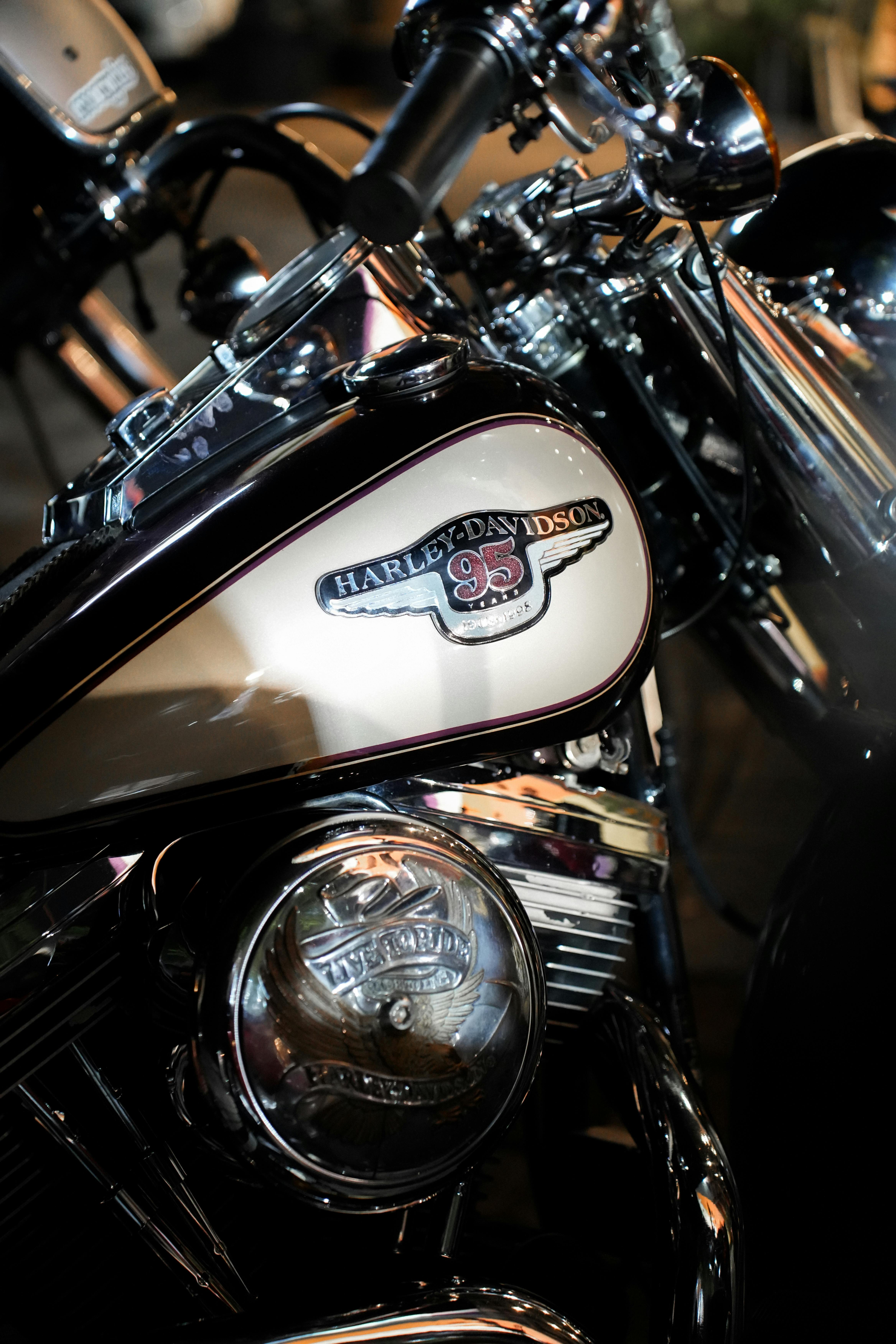 Detailed shot of a classic motorcycle engine with a shiny chrome finish under artificial lighting.