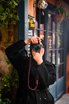 Street portrait of woman photographer capturing essence of city life.
