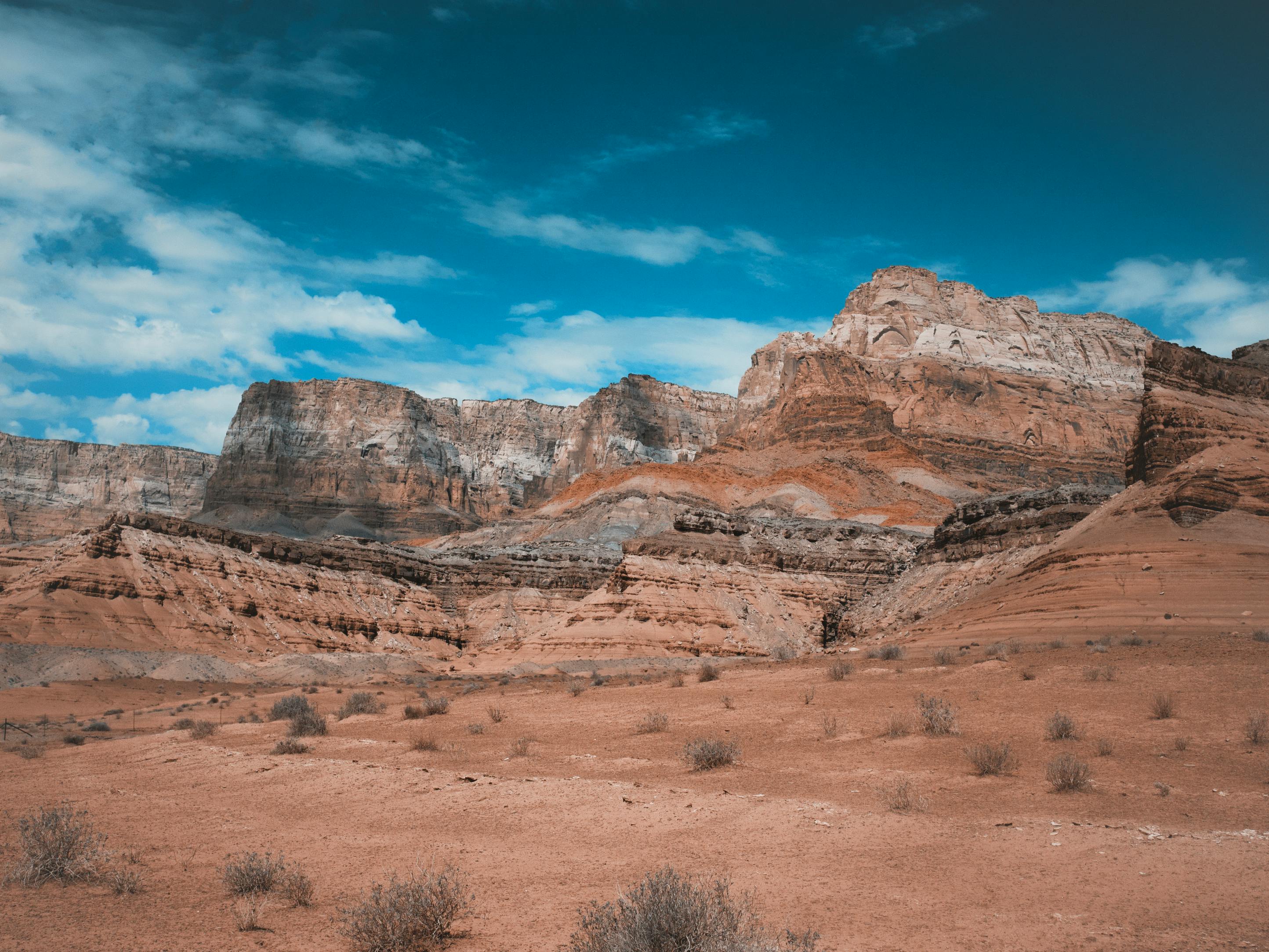 Stunning view of sandstone cliffs under a bright sky in Marble Canyon, Arizona.