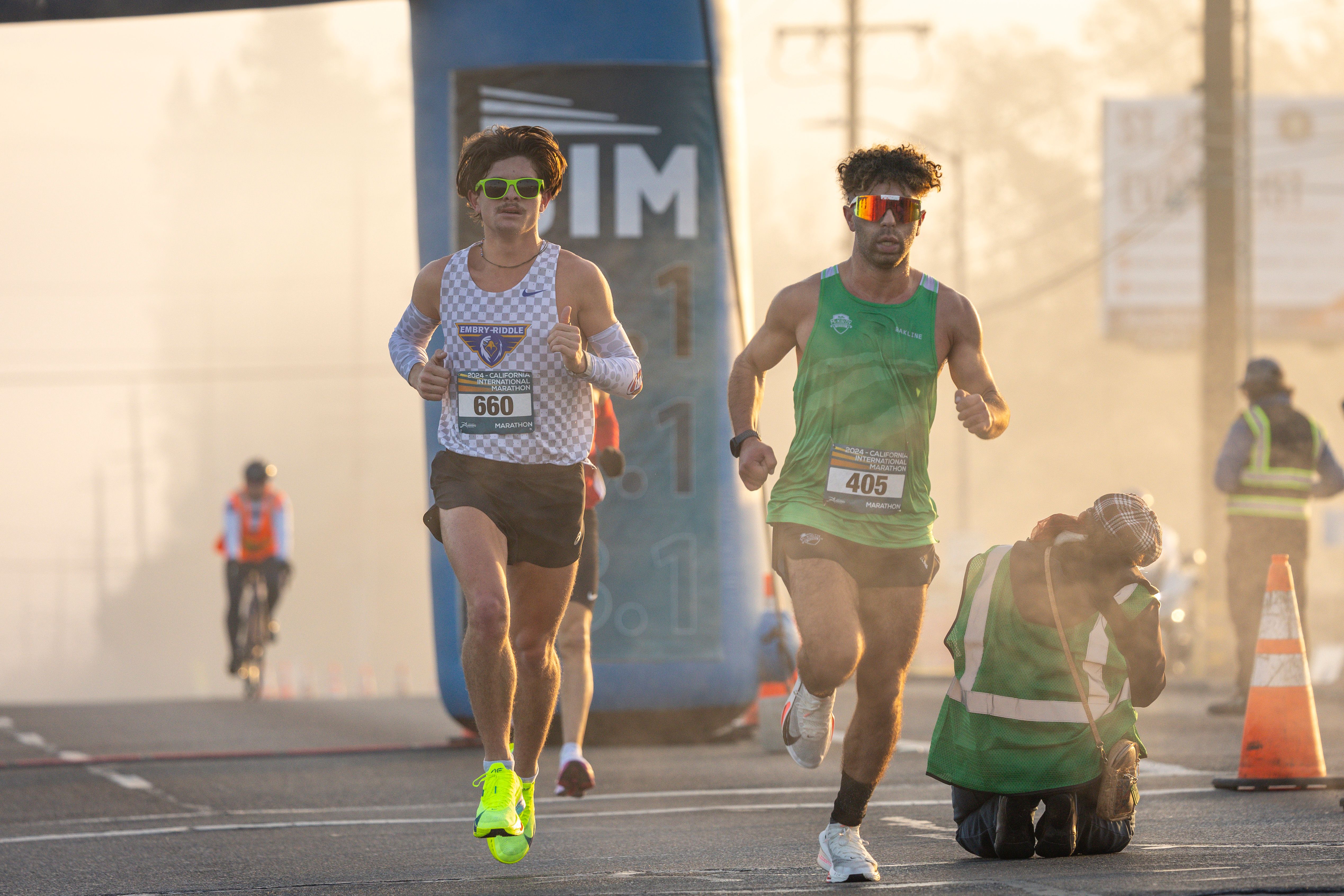 Runner crossing a finish line with a clock showing their time