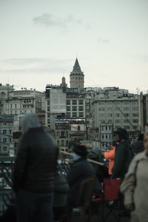 Free A view of fishermen on Galata Bridge with the iconic Galata Tower in Istanbul at dusk. Stock Photo