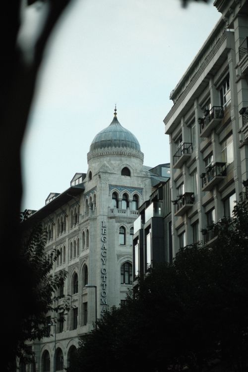 Free Elegant view of Legacy Ottoman Hotel's dome among city buildings. Stock Photo