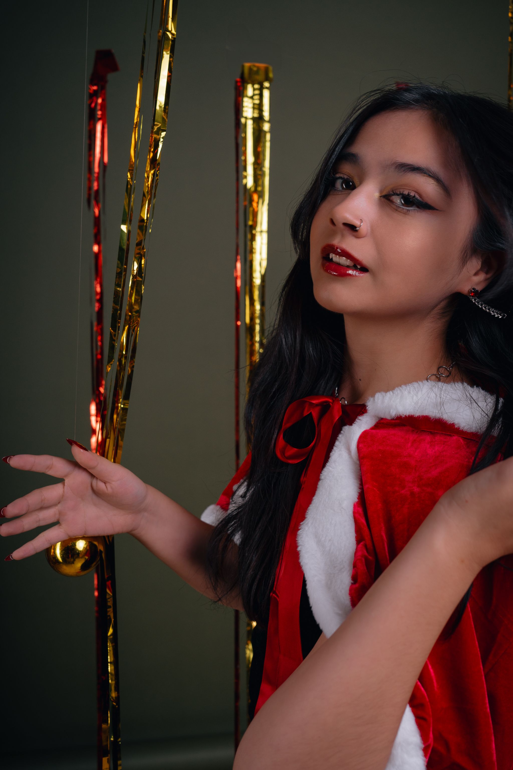 Festive Woman in Santa Costume with Streamers · Free Stock Photo