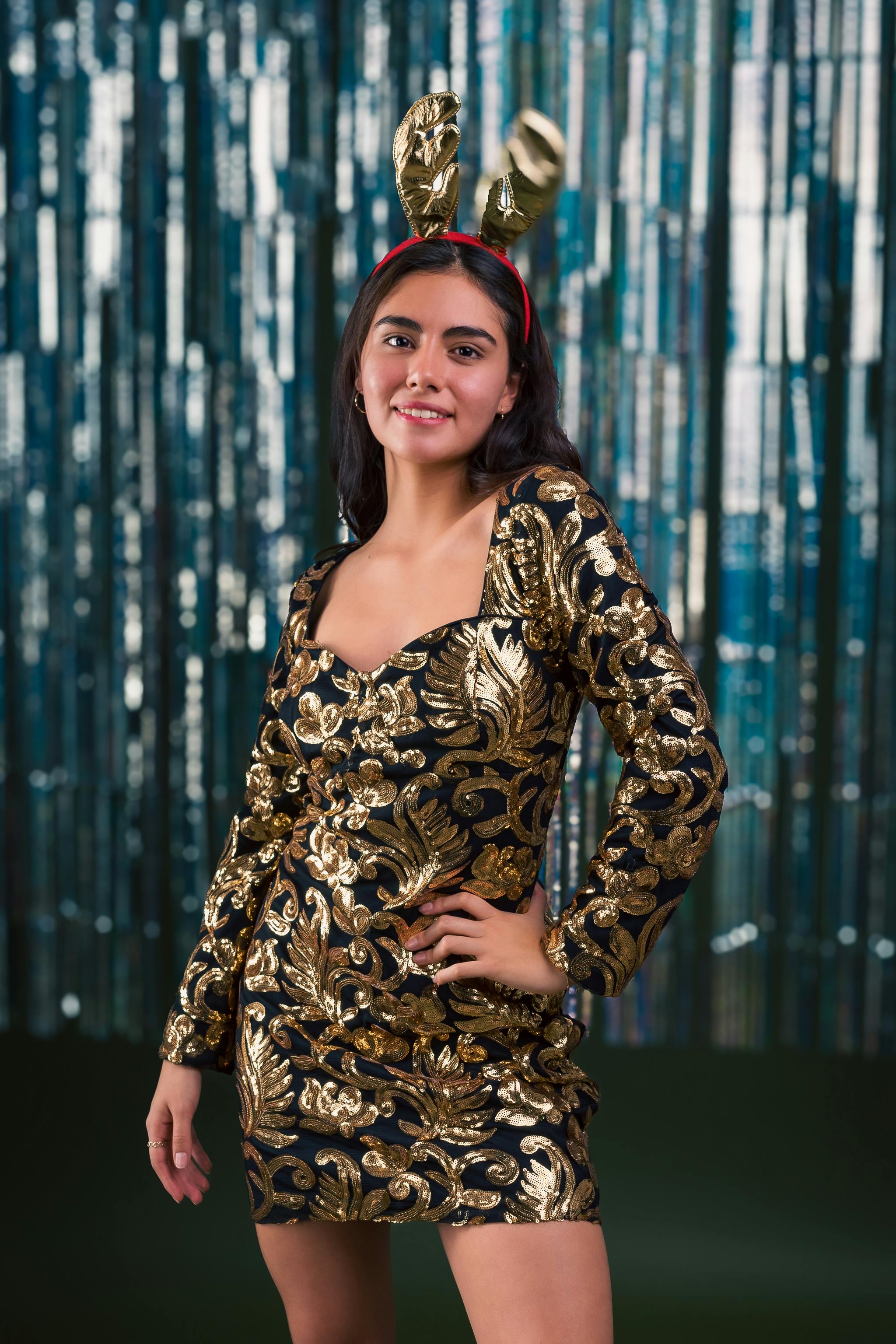 festive woman in gold dress with bunny ears