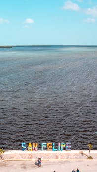 Vibrant aerial view of the San Felipe beachfront promenade in Yucatan, Mexico under a clear blue sky.