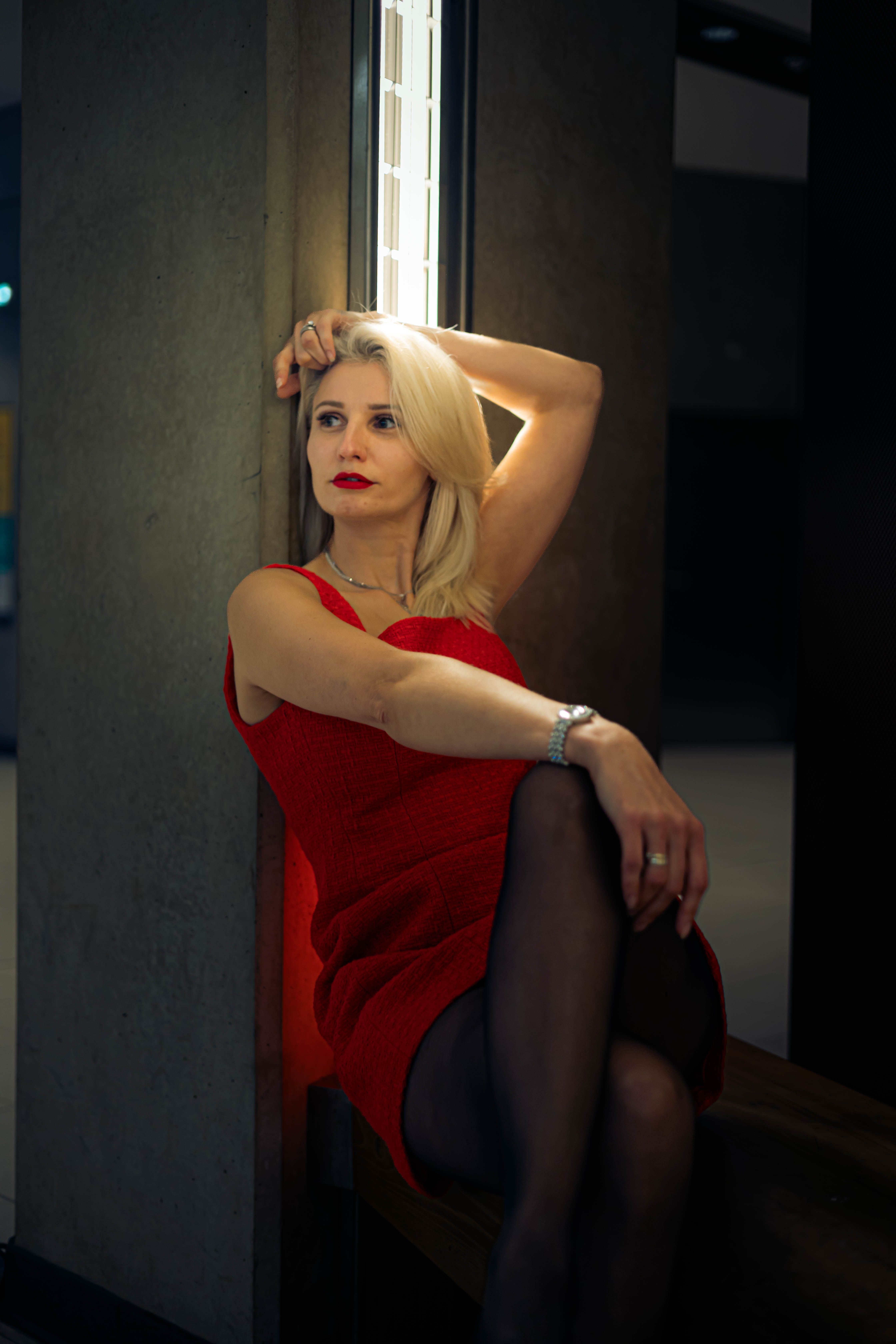 Elegant Woman in Red Dress Relaxing Indoors · Free Stock Photo