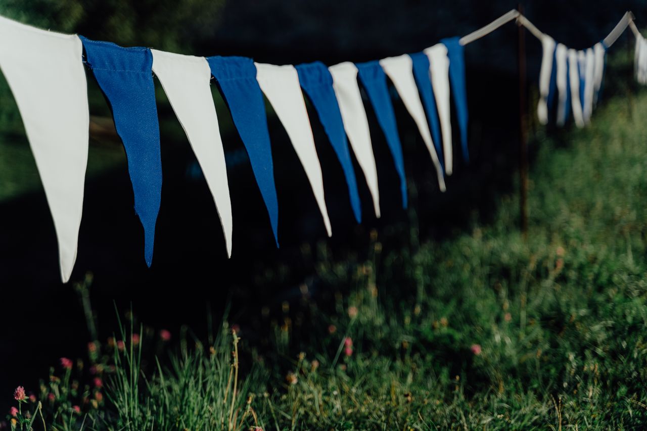 classic-bunting-on-the-porch Blue and white pennant bunting strung along a line outdoors
