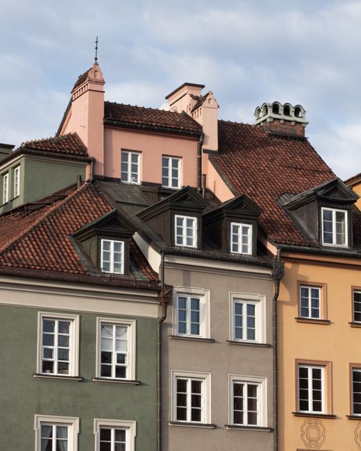 Colorful European-style townhouses with classic architecture under a clear sky. Vibrant and picturesque cityscape.