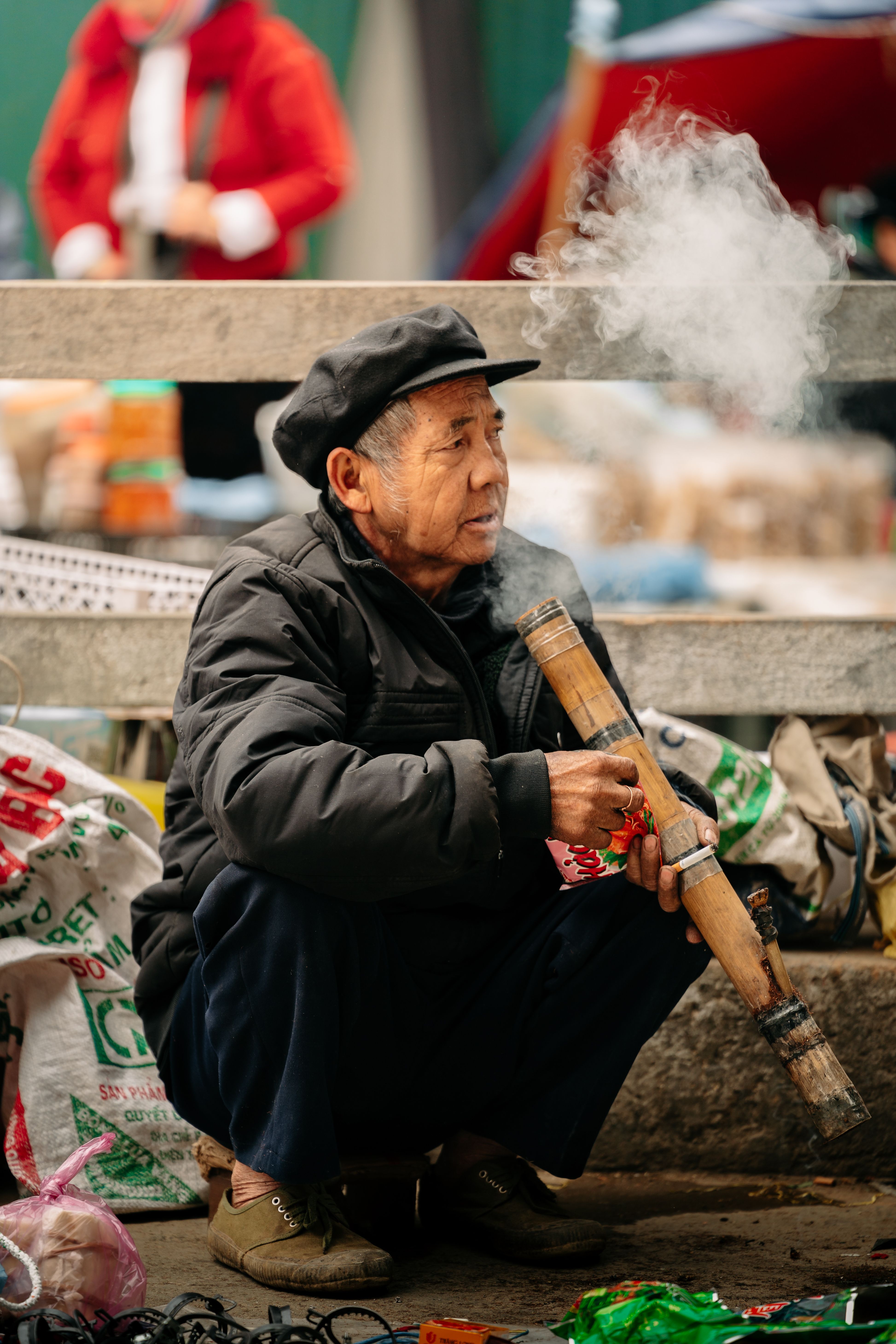 Elderly Man Smoking Bamboo Pipe in Ha Giang Market · Free Stock Photo