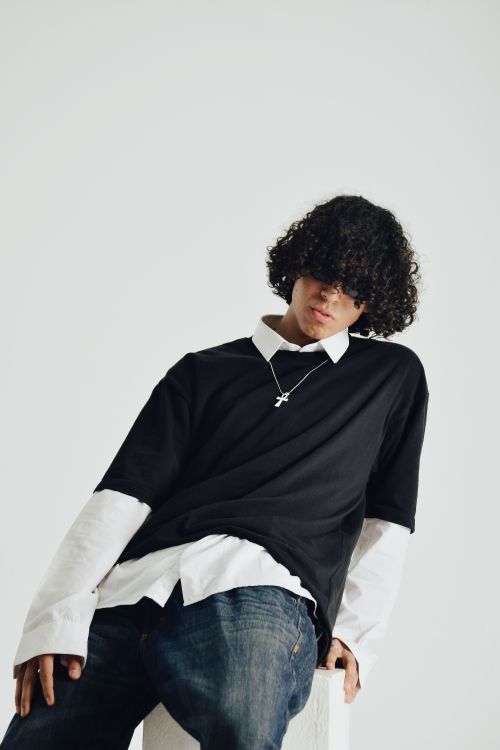 Free Stylish young adult in layered fashion, photographed in a Cairo studio. Stock Photo