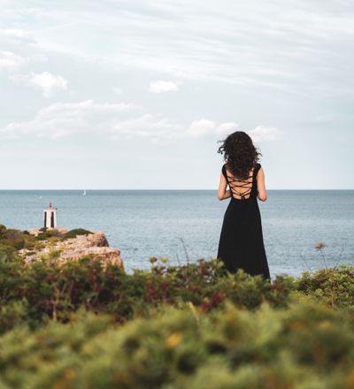 Woman watching the sea at dusk, photo by Iulian Sandu on Pexels