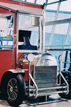A vibrant retro-style kiosk at Almaty airport resembling a classic car, perfect for nostalgic themes.