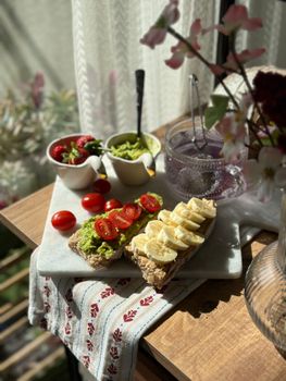 Inviting brunch setting featuring avocado and banana toast with fresh fruits.