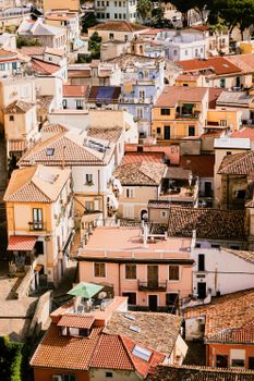 Aerial view of Italian rooftops with colorful facades under bright sunlight.