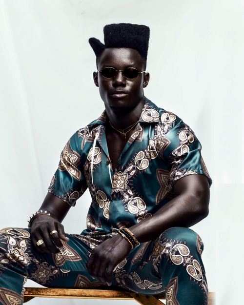 Free Confident man in a vibrant patterned outfit, exuding style and poise. Stock Photo