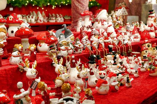 Free A vibrant display of festive Christmas decorations with reindeer and snowmen figurines for holiday season. Stock Photo