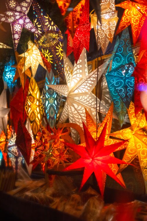Free Colorful illuminated stars at a Dresden Christmas market create a festive winter atmosphere. Stock Photo