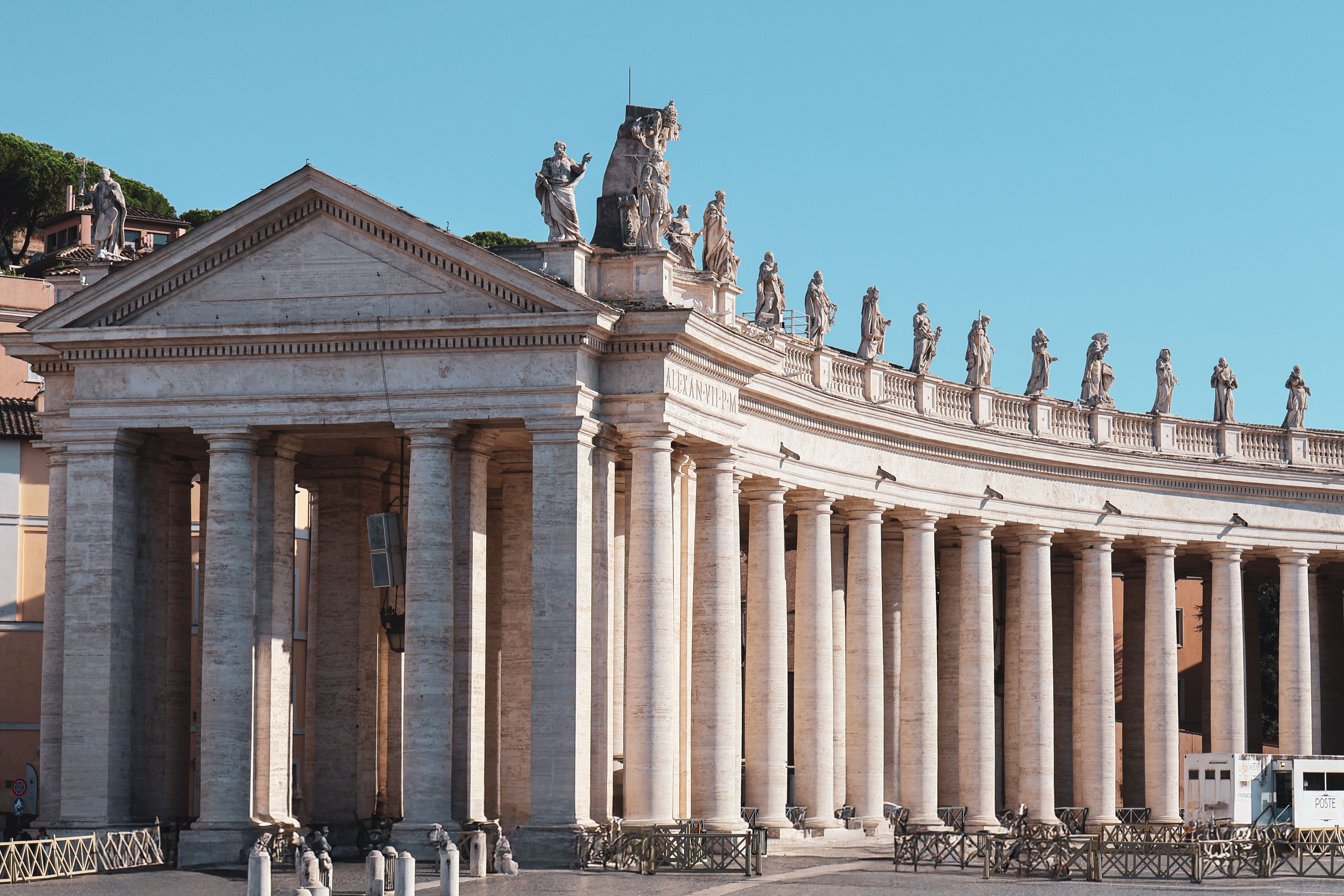 Magnificent architectural columns and statues in Vatican City's St. Peter's Square.