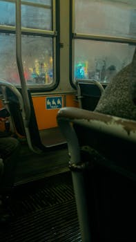 Interior of a classic tram during a rainy evening, showcasing urban transport mood.