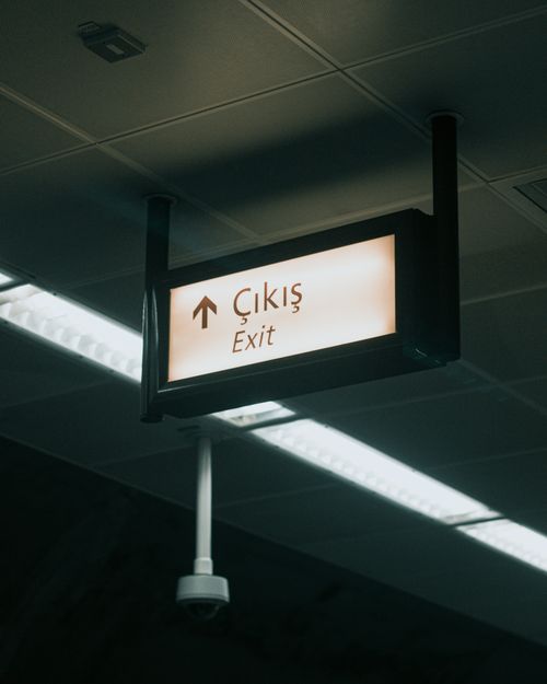Free An illuminated exit sign with Turkish text in an indoor setting, ideal for safety and travel themes. Stock Photo
