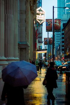 Explore the urban charm of a rainy evening in downtown Toronto's bustling city streets.