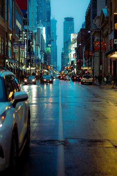 A bustling Toronto street scene on a winter evening, capturing urban life in Ontario.