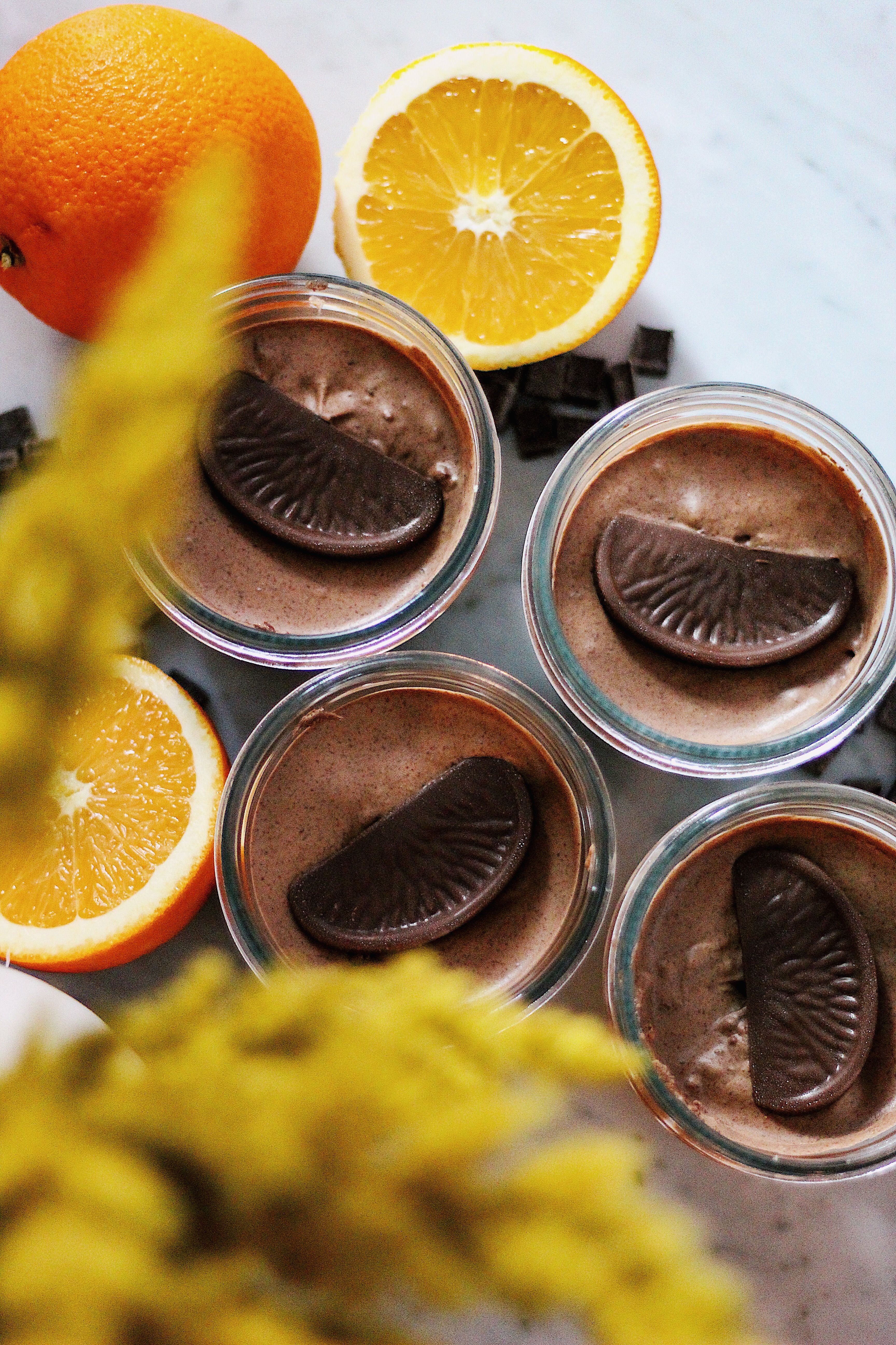 Artisan chocolate orange mousse with fresh citrus and chocolate garnishing.