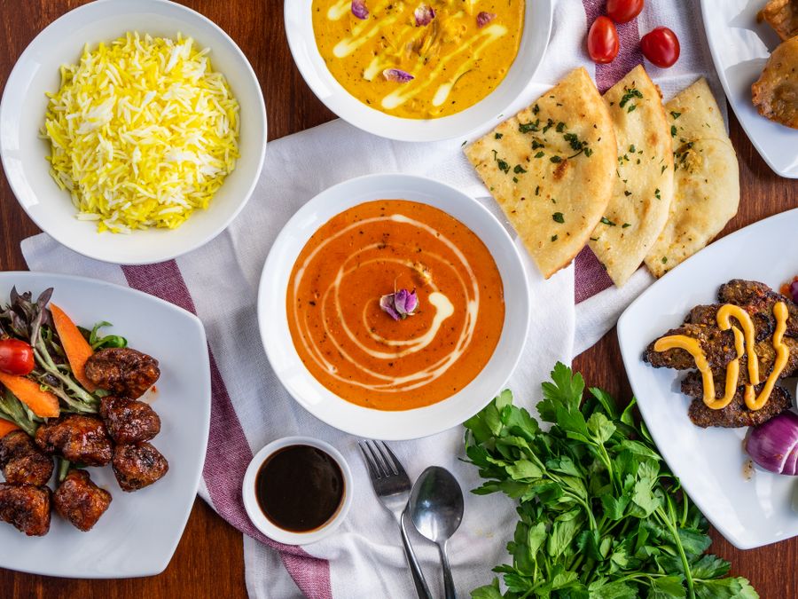A spread of Indian curries, naan and biryani for a large gathering